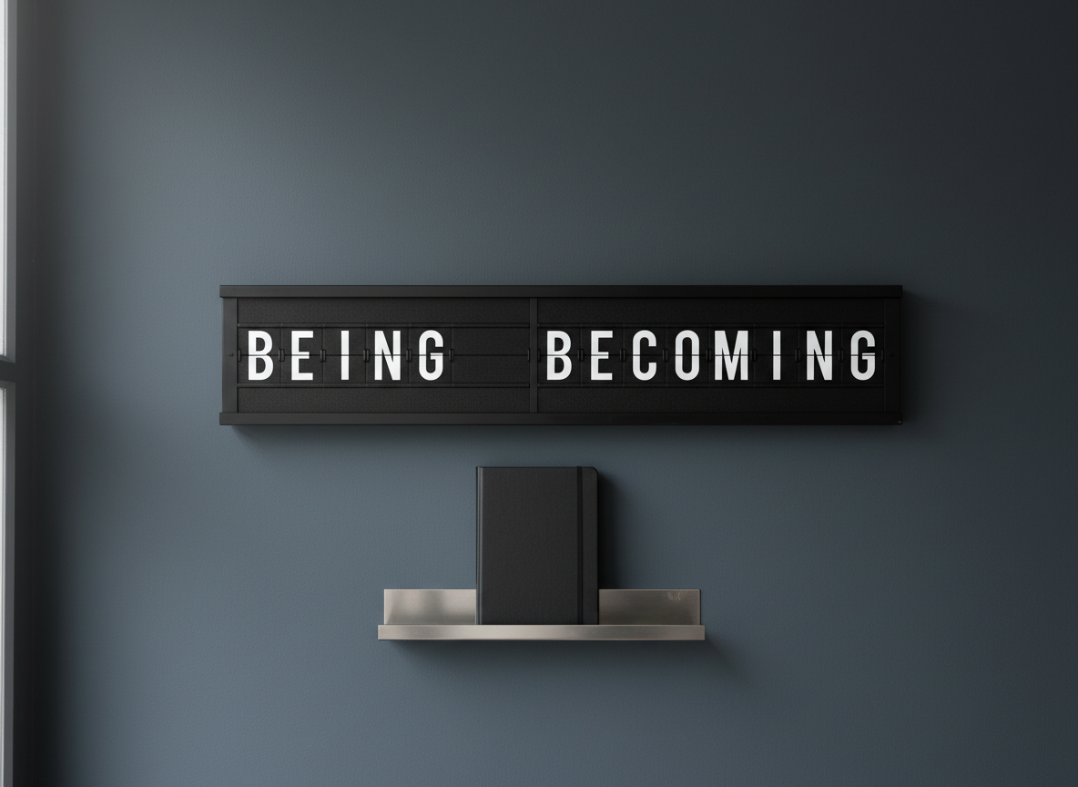 An old-fashioned split-flap departure board, its surface divided cleanly down the middle, displays two alternating words in stark white letters on matte-black tiles, each side frozen on a different philosophical term. The board hangs on a smooth, slate-gray wall above a narrow metal shelf holding only a single, closed black notebook. Soft, overcast window light from the left grazes the tiles, catching the subtle texture of the plastic and casting gentle, rhythmic shadows beneath each row. Shot in photographic realism from a slightly low angle with the board on the upper third, the mood is contemplative, mechanical, and quietly binary, as if ideas are constantly flipping between two poles.
